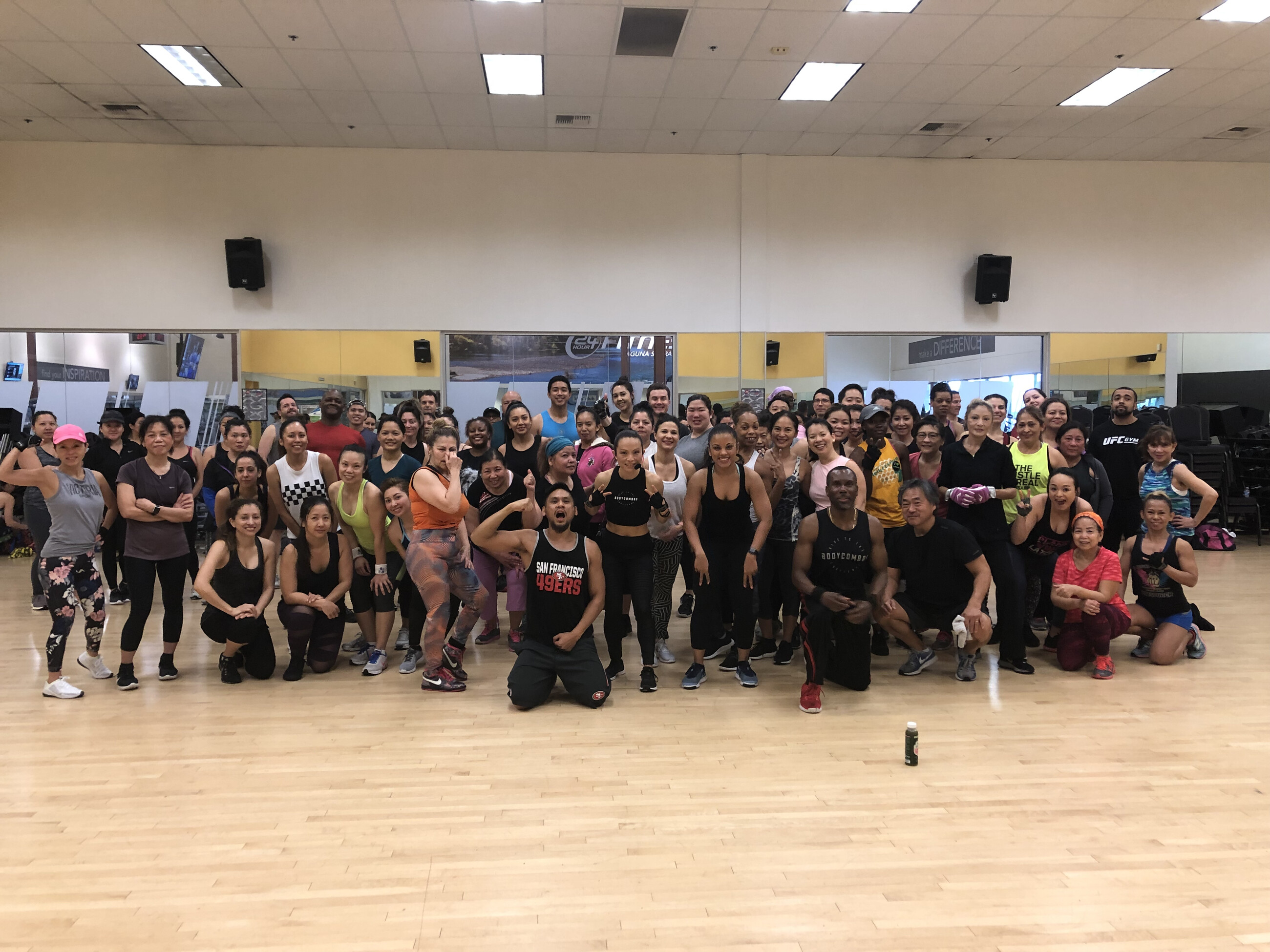 A large Stay Fit For Life group fitness class packed with dozens of smiling clients